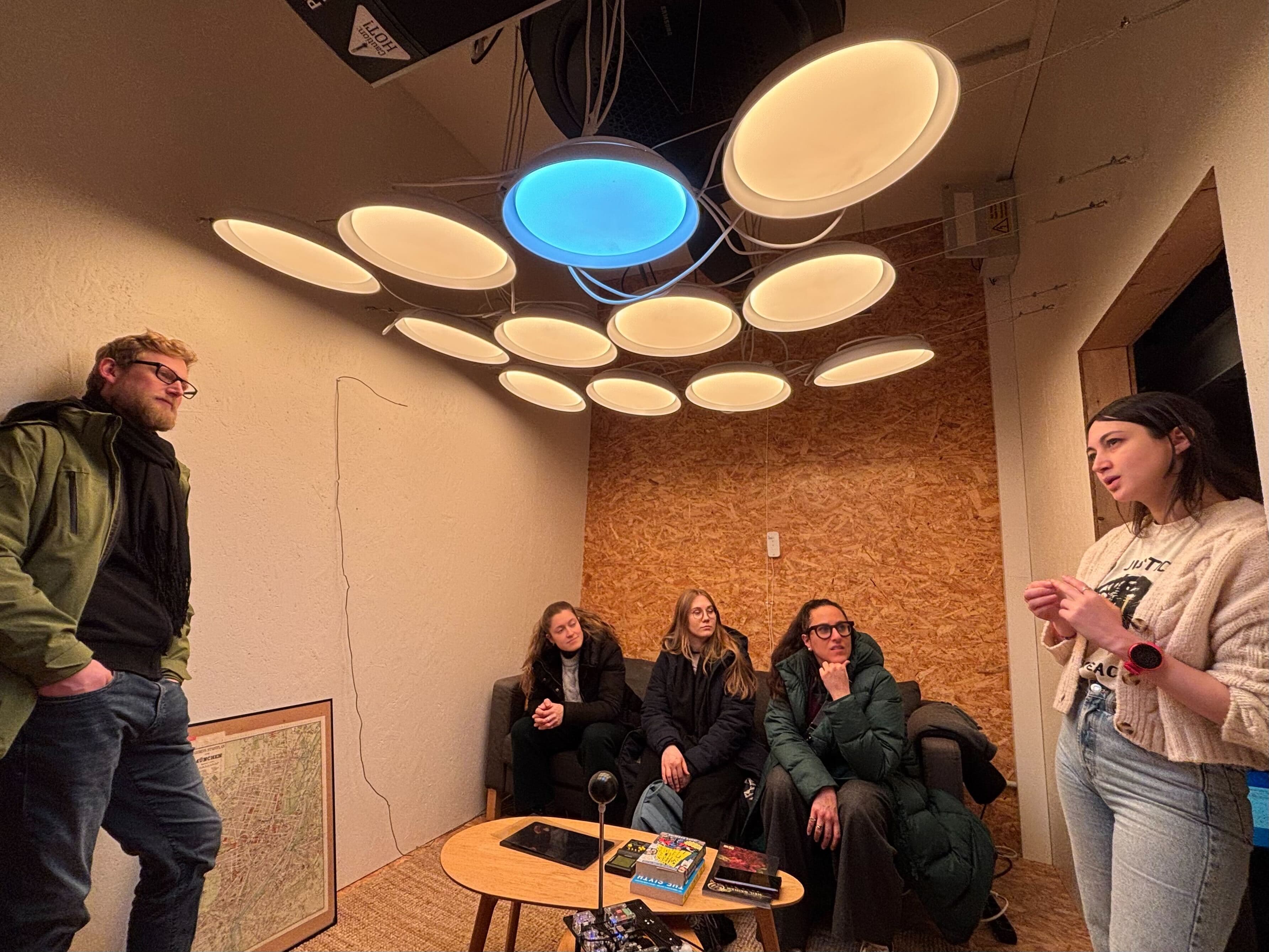 GLEE team discussion under light installation